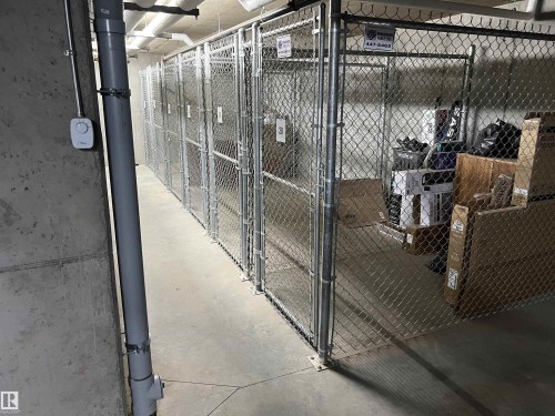 Indoor storage units featuring chain-link construction and concrete flooring - 318 1506 Tamarack Boulevard, Edmonton, AB 