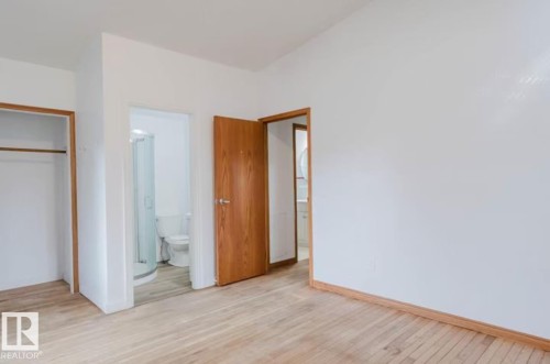 Light wood-finish flooring with white baseboards and walls - 10948 75 Avenue, Edmonton, AB 