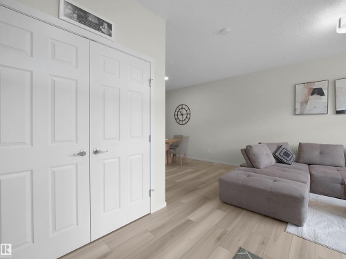 Light wood-finish flooring extending throughout the living space - 5022 Kinney Link Sw, Edmonton, AB 
