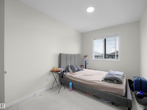 Bright interior featuring light-colored walls and grey carpeting - 5022 Kinney Link Sw, Edmonton, AB 