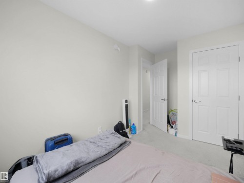 Neutral wall paint, white trim, and white paneled doors - 5022 Kinney Link Sw, Edmonton, AB 