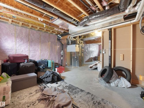 Unfinished basement space featuring exposed wood joists and structural framing - 5022 Kinney Link Sw, Edmonton, AB 