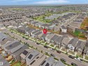 Aerial perspective showcasing a residential neighborhood with a prominent body of water and green spaces - 5022 Kinney Link Sw, Edmonton, AB 