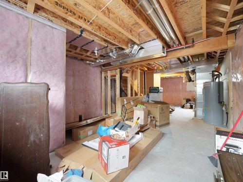 Unfinished basement with exposed wooden joists and insulated walls - 5022 Kinney Link Sw, Edmonton, AB 