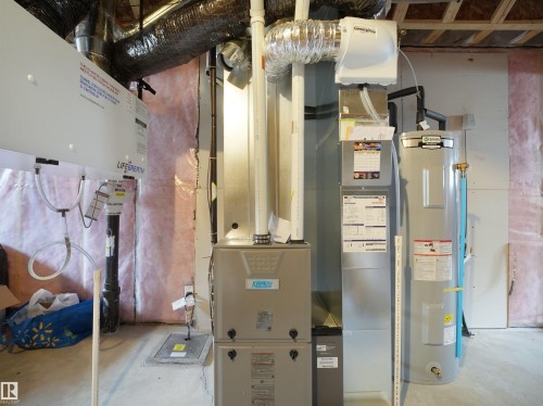 Mechanical room featuring a water heater, furnace, and ventilation system - 5022 Kinney Link Sw, Edmonton, AB 