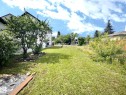 Expansive grass lawn with mature trees and a partial wood fence - 9551 85 Street, Edmonton, AB 