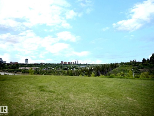 Expansive green space featuring a distant cityscape, natural tree lines, and a river - 9551 85 Street, Edmonton, AB 
