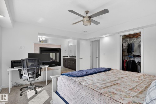 Carpeted bedroom featuring a ceiling fan with integrated lighting, recessed lighting, and a closet with wire shelving - 704 39 Street, Edmonton, AB 