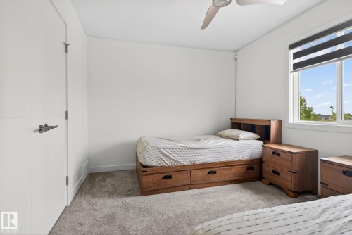 Bright room with a large window featuring roller blinds - 704 39 Street, Edmonton, AB 