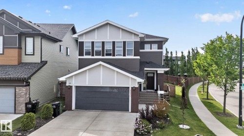 Modern two-story residence featuring a dark gray siding facade and white trim accents - 704 39 Street, Edmonton, AB 