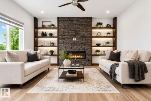 Living area featuring a stone accent wall with an integrated linear fireplace - 704 39 Street, Edmonton, AB 