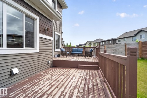 Spacious outdoor wood deck with perimeter railing and steps down to a lower deck section - 704 39 Street, Edmonton, AB 