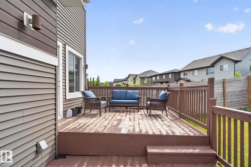 Expansive rear deck featuring a wood-finish surface, complete with matching wood railings - 704 39 Street, Edmonton, AB 