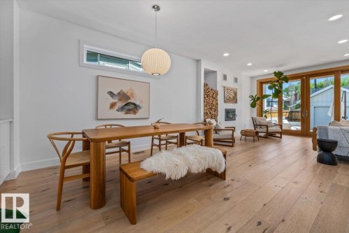 Expansive wood-finish flooring throughout the open-concept living area - 10641 126 Street, Edmonton, AB 
