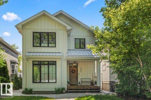 Modern farmhouse exterior featuring vertical board-and-batten siding - 10641 126 Street, Edmonton, AB 