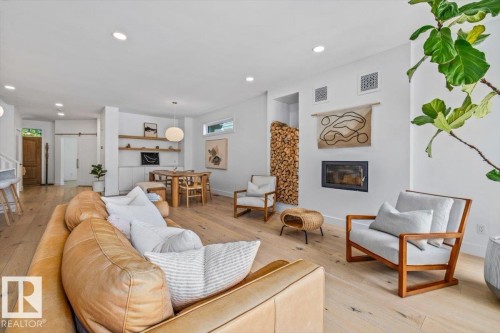 Open-concept living area featuring light wood-finish flooring - 10641 126 Street, Edmonton, AB 