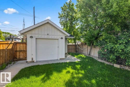 Detached garage with white siding and a paneled garage door - 10641 126 Street, Edmonton, AB 