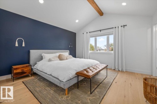 Vaulted ceiling featuring an exposed beam, light wood-finish flooring, recessed lighting, and a painted accent wall - 10641 126 Street, Edmonton, AB 