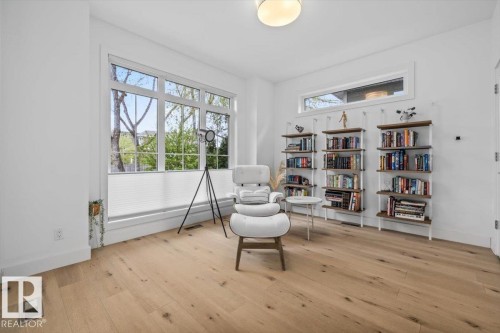 Bright interior space featuring wood-finish flooring and white walls - 10641 126 Street, Edmonton, AB 