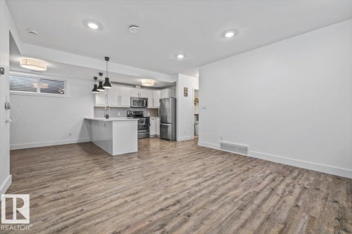 Open-concept living area featuring wood-finish flooring - 10641 126 Street, Edmonton, AB 