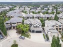 Spacious home featuring a multi-car garage, extensive concrete driveway, and mature landscaping - 3310 Watson Bay, Edmonton, AB 