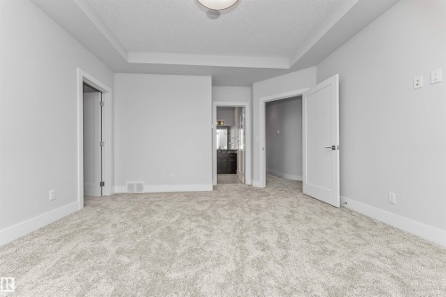 Neutral tone carpeting paired with white baseboards and light gray walls - 3310 Watson Bay, Edmonton, AB 