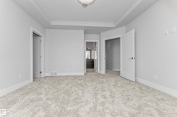 Neutral tone carpeting paired with white baseboards and light gray walls - 