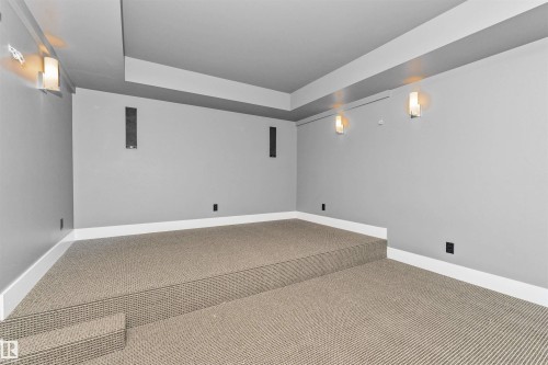 Tiered carpeted flooring with integrated sound system speakers - 3310 Watson Bay, Edmonton, AB 