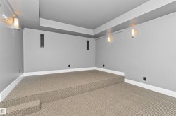 Tiered carpeted flooring with integrated sound system speakers - 