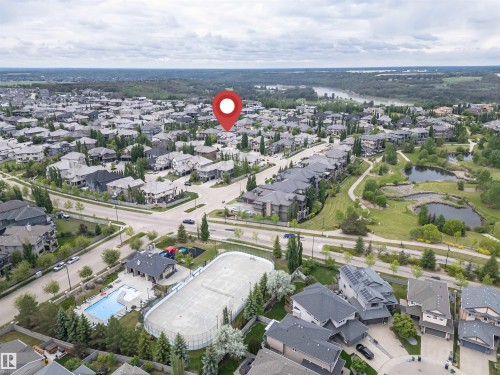 Suburban neighborhood featuring varied residential architecture, established streetscapes, and a prominent green space with water features - 3310 Watson Bay, Edmonton, AB 