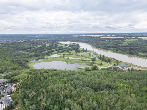 Expansive aerial panorama showcasing a meandering river, a golf course with multiple water features, and dense mature forest - 3310 Watson Bay, Edmonton, AB 