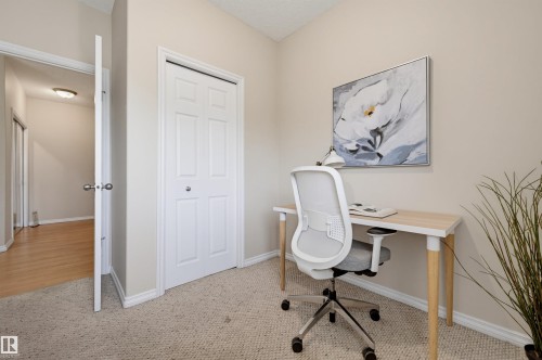 Carpeted room featuring neutral wall tones and white baseboards - 203 10719 80 Avenue, Edmonton, AB 