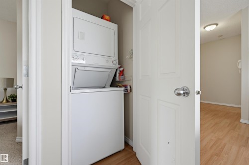 Dedicated laundry closet with a stacked washer and dryer unit - 203 10719 80 Avenue, Edmonton, AB 