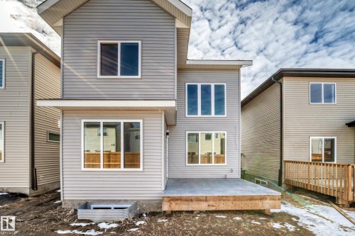 Rear exterior featuring light gray siding - 341 Roberts Wynd, Leduc, AB 
