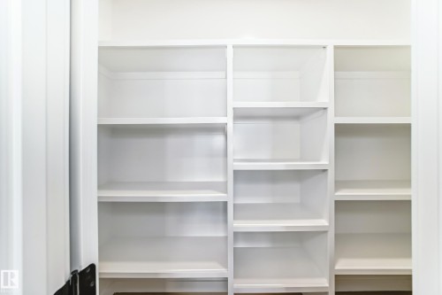 Built-in white shelving unit with multiple compartments - 341 Roberts Wynd, Leduc, AB 