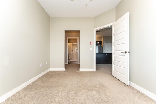 Neutral-toned carpeting throughout - 505 1230 Windermere Way, Edmonton, AB 