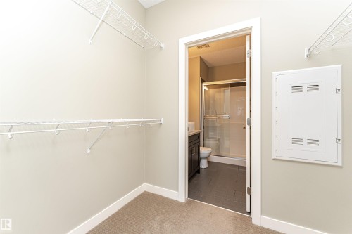 Walk-in closet with wire shelving and carpeting - 505 1230 Windermere Way, Edmonton, AB 