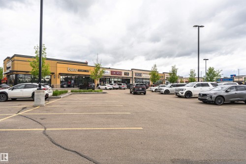 Retail storefronts featuring expansive glass facades - 505 1230 Windermere Way, Edmonton, AB 