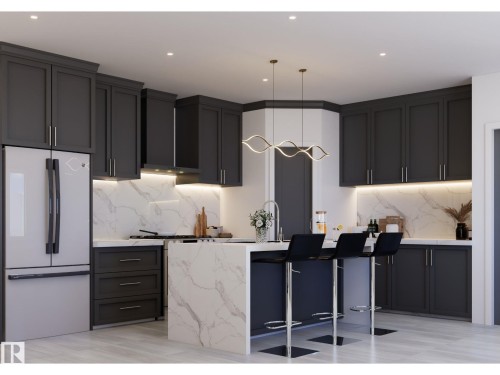 Gourmet kitchen featuring dark shaker-style cabinetry, a waterfall island with a sink and seating, integrated stainless steel appliances, and under-cabinet lighting illuminating a stone backsplash - 10919 106 Ave, Westlock, AB 