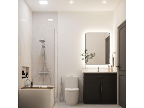 Bathroom featuring a dark wood-finish vanity with a light-colored countertop, an illuminated rectangular mirror, and a built-in shower/tub combination with a wall-mounted showerhead and separate handheld sprayer - 10919 106 Ave, Westlock, AB 
