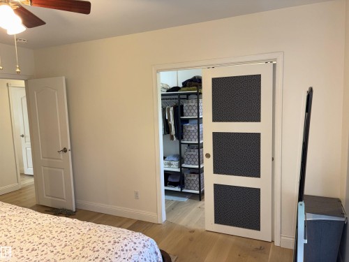 Light wood-finish flooring with white baseboards throughout - 14016 85 Avenue, Edmonton, AB 