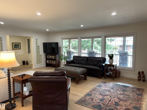 Living area featuring light wood-finish flooring, recessed lighting, and crown molding - 14016 85 Avenue, Edmonton, AB 