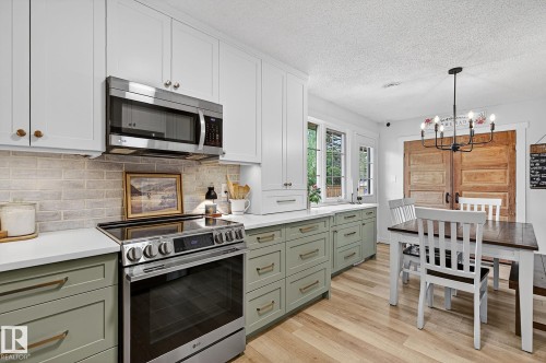 New custom-built kitchen with loads of drawers and cabinets with hidden drawers. Brick backsplash, countertop lighting. Newer LG appliances - 9 Millgrove Drive, Spruce Grove, AB 