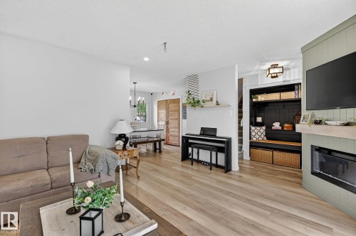 Living room with new flooring and electric fireplace - 9 Millgrove Drive, Spruce Grove, AB 