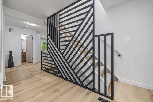 Modern black metal staircase railing with geometric design - 7 Glacier Place, St. Albert, AB 