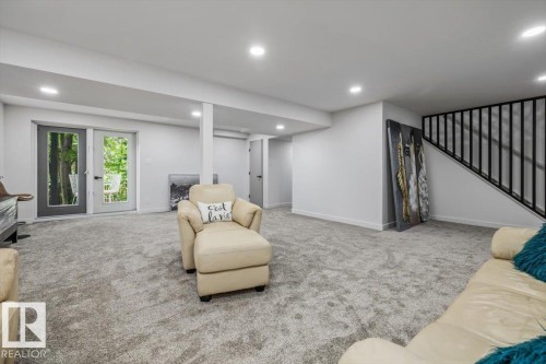 Spacious lower-level area featuring light gray carpeting, recessed ceiling lighting, and crisp white walls - 7 Glacier Place, St. Albert, AB 