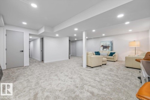Expansive open-concept room featuring plush light-toned carpeting and recessed lighting - 7 Glacier Place, St. Albert, AB 