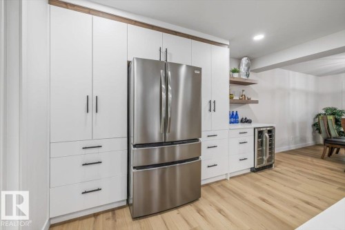 Built-in cabinetry with a stainless steel refrigerator and beverage cooler - 7 Glacier Place, St. Albert, AB 