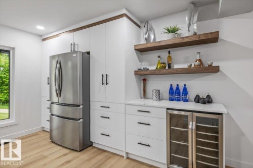 Modern kitchen area featuring light wood-finish flooring - 7 Glacier Place, St. Albert, AB 
