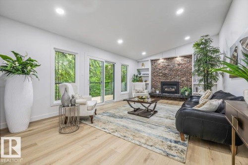 Overlooking ravine and park   clinker brick fireplace with custom built ins - 7 Glacier Place, St. Albert, AB 